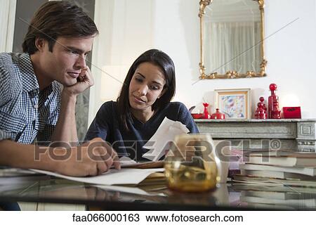 Couple reviewing their finances View Large Photo Image Stock Image - Couple reviewing their finances. Fotosearch