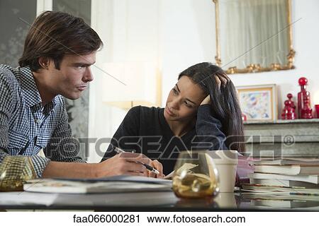 Couple reviewing their finances together View Large Photo Image Stock Image - Couple reviewing their finances together. Fotosearch