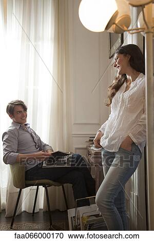 Stock Image - Couple talking together at home. Fotosearch