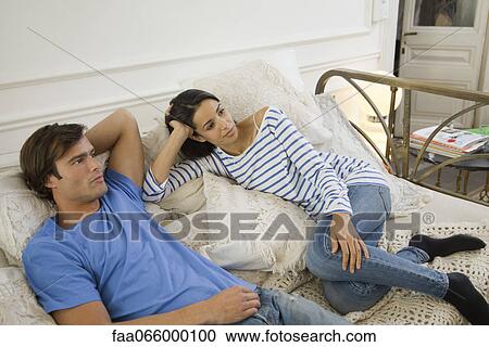 Couple watching TV together View Large Photo Image Stock Image - Couple watching TV together. Fotosearch