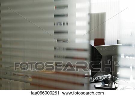 Empty office seen through glass wall View Large Photo Image Stock Image - Empty office seen through glass wall. Fotosearch