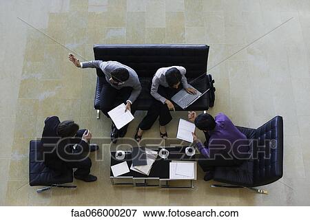 Executives having meeting, overhead view View Large Photo Image Stock Photo - Executives having meeting, overhead view. Fotosearch