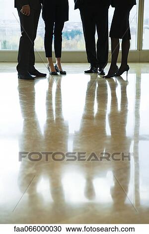Executives standing together in lobby, low section View Large Photo Image Stock Image - Executives standing together in lobby, low section. Fotosearch