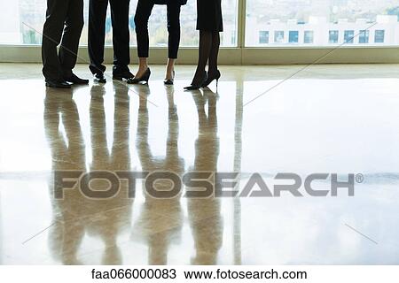 Executives standing together in lobby, low section View Large Photo Image Stock Image - Executives standing together in lobby, low section. Fotosearch