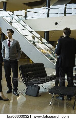 Executives talking in lobby after meeting View Large Photo Image Stock Image - Executives talking in lobby after meeting. Fotosearch