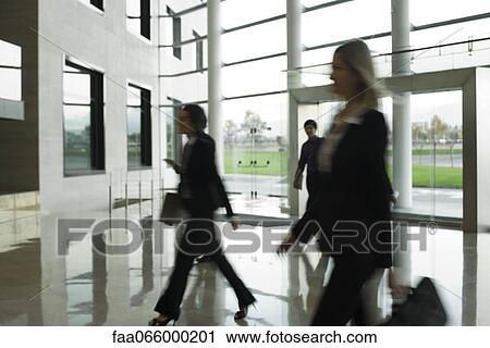 Executives walking in lobby View Large Photo Image Stock Image - Executives walking in lobby. Fotosearch