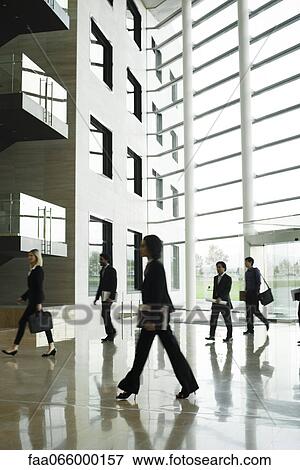 Executives walking in lobby View Large Photo Image Stock Photo - Executives walking in lobby. Fotosearch