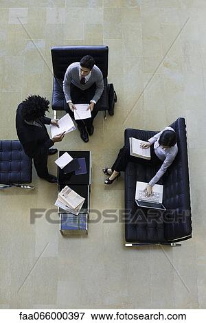 Executives working together, overhead view View Large Photo Image Stock Photo - Executives working together, overhead view. Fotosearch