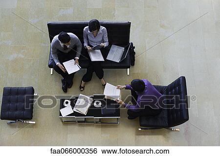Executives working together, overhead view View Large Photo Image Stock Photograph - Executives working together, overhead view. Fotosearch