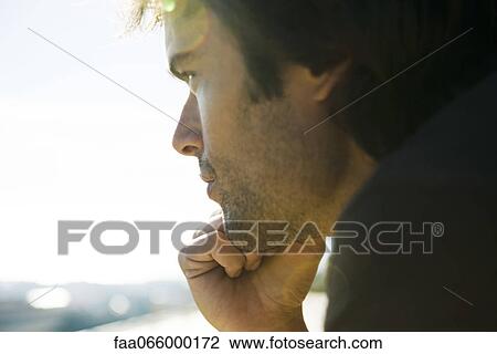 Man looking away in thought, hand under chin View Large Photo Image Stock Image - Man looking away in thought, hand under chin. Fotosearch