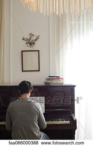 Man playing piano, rear view View Large Photo Image Stock Photo - Man playing piano, rear view. Fotosearch
