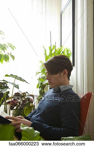 Man reading at home View Large Photo Image Stock Image - Man reading at home. Fotosearch