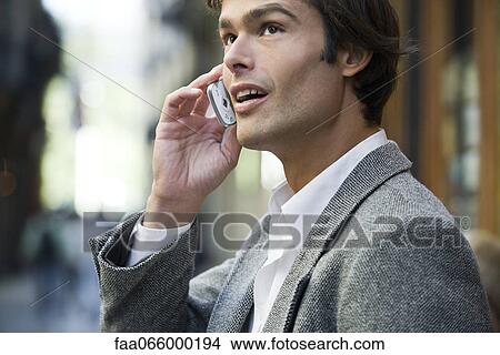 Man talking on cell phone outdoors View Large Photo Image Picture - Man talking on cell phone outdoors. Fotosearch