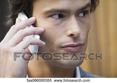 Man talking on cell phone outdoors View Large Photo Image Stock Photography - Man talking on cell phone outdoors. Fotosearch