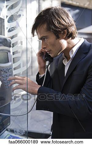 Man using pay phone View Large Photo Image Stock Photo - Man using pay phone. Fotosearch