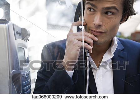 Man using pay phone View Large Photo Image Stock Photo - Man using pay phone. Fotosearch
