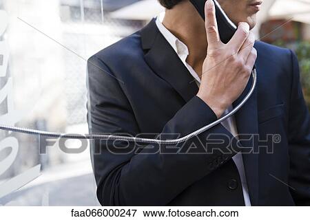 Man using pay phone View Large Photo Image Stock Photo - Man using pay phone. Fotosearch