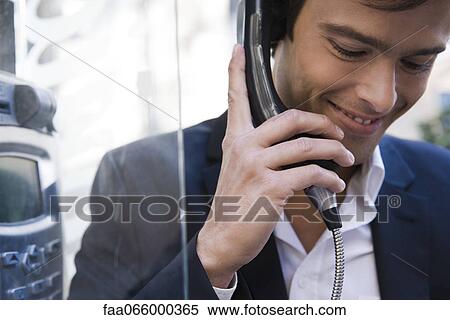 Man using pay phone View Large Photo Image Stock Photography - Man using pay phone. Fotosearch