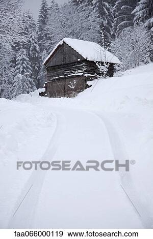 Tire tracks leading up to house on the hill in wintery landscape View Large Photo Image Stock Photo - Tire tracks leading up to house on the hill in wintery landscape. Fotosearch