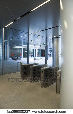 Turnstiles in office building lobby View Large Photo Image Stock Photo - Turnstiles in office building lobby. Fotosearch