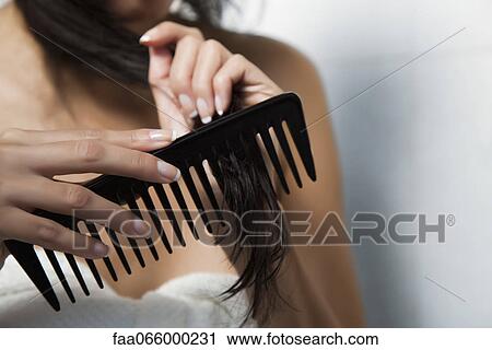 Woman combing her hair, cropped View Large Photo Image Stock Image - Woman combing her hair, cropped. Fotosearch