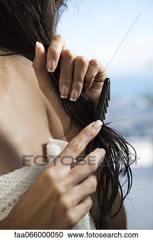 Woman combing wet hair, cropped View Large Photo Image Stock Image - Woman combing wet hair, cropped. Fotosearch