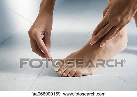 Woman giving herself a pedicure, cropped View Large Photo Image Stock Photo - Woman giving herself a pedicure, cropped. Fotosearch