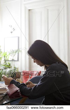 Woman going over her finances View Large Photo Image Stock Image - Woman going over her finances. Fotosearch