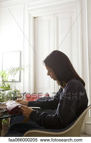 Woman going over her finances View Large Photo Image Stock Photography - Woman going over her finances. Fotosearch