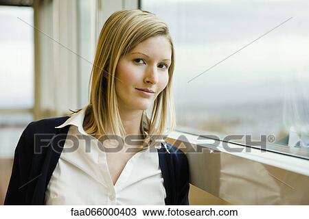 Woman leaning against window, portrait View Large Photo Image Stock Image - Woman leaning against window, portrait. Fotosearch