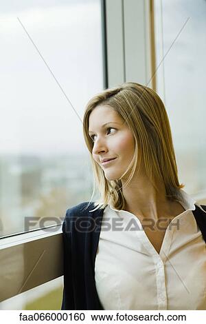 Woman looking out window, portrait View Large Photo Image Stock Image - Woman looking out window, portrait. Fotosearch