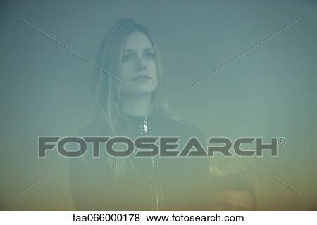 Woman looking through window View Large Photo Image Stock Photo - Woman looking through window. Fotosearch