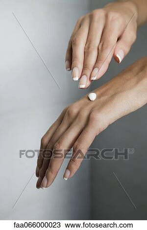 Woman moisturizing hands, cropped View Large Photo Image Stock Image - Woman moisturizing hands, cropped. Fotosearch