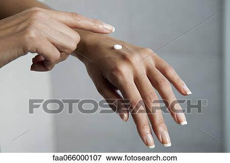 Woman moisturizing hands, cropped View Large Photo Image Stock Photo - Woman moisturizing hands, cropped. Fotosearch