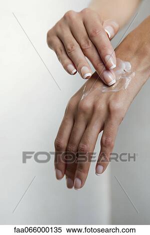 Woman moisturizing hands, cropped View Large Photo Image Stock Photography - Woman moisturizing hands, cropped. Fotosearch