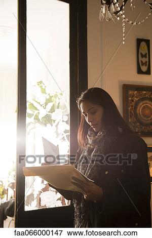 Stock Photo - Woman opening her mail. Fotosearch