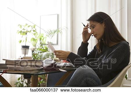 Woman reviewing her finances View Large Photo Image Stock Photo - Woman reviewing her finances. Fotosearch