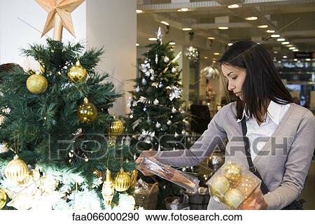Woman shopping for Christmas decorations View Large Photo Image Stock Image - Woman shopping for Christmas decorations. Fotosearch