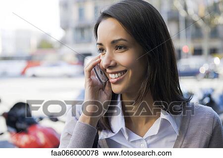 Woman talking on cell phone outdoors View Large Photo Image Stock Photo - Woman talking on cell phone outdoors. Fotosearch