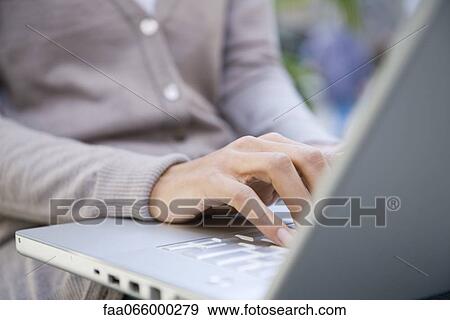 Woman using laptop computer, cropped View Large Photo Image Stock Photo - Woman using laptop computer, cropped. Fotosearch