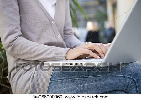 Woman using laptop computer outdoors View Large Photo Image Stock Image - Woman using laptop computer outdoors. Fotosearch