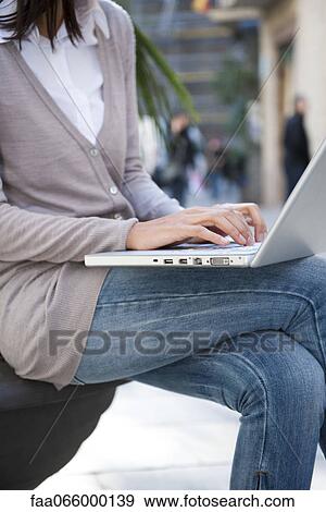 Woman using laptop computer outdoors View Large Photo Image Stock Photo - Woman using laptop computer outdoors. Fotosearch