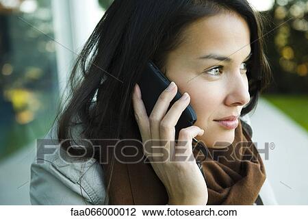 Young woman using cell phone, portrait View Large Photo Image Stock Image - Young woman using cell phone, portrait. Fotosearch