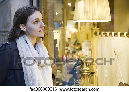 Young woman window shopping View Large Photo Image Stock Photograph - Young woman window shopping. Fotosearch