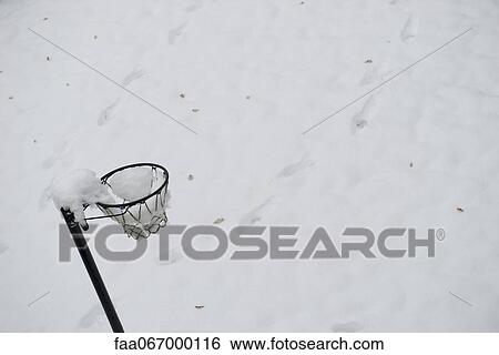 Stock Photograph - Basketball hoop covered in snow. Fotosearch