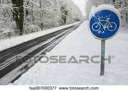 Stock Photo - Bicycle path sign in winter. Fotosearch