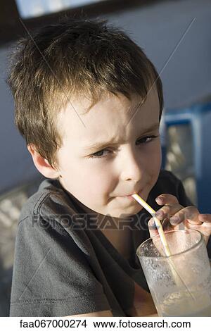 Picture - Boy drinking through straw, portrait. Fotosearch