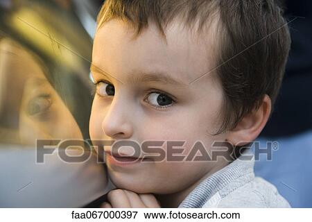 Boy glancing sideways at camera, portrait View Large Photo Image Stock Photo - Boy glancing sideways at camera, portrait. Fotosearch