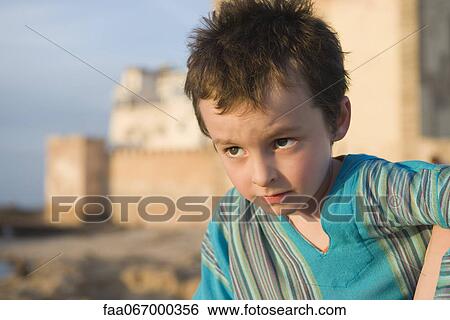 Boy looking away in thought, portrait View Large Photo Image Stock Photograph - Boy looking away in thought, portrait. Fotosearch