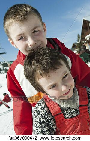 Stock Image - Brothers outdoors, portrait. Fotosearch